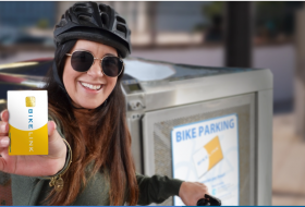 Female holding bike link card