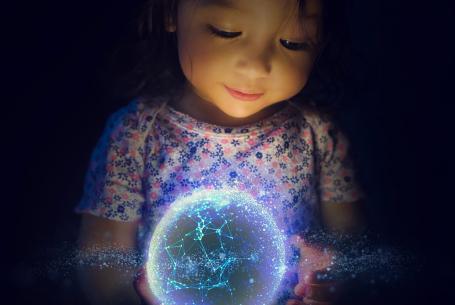 child holding an electric globe